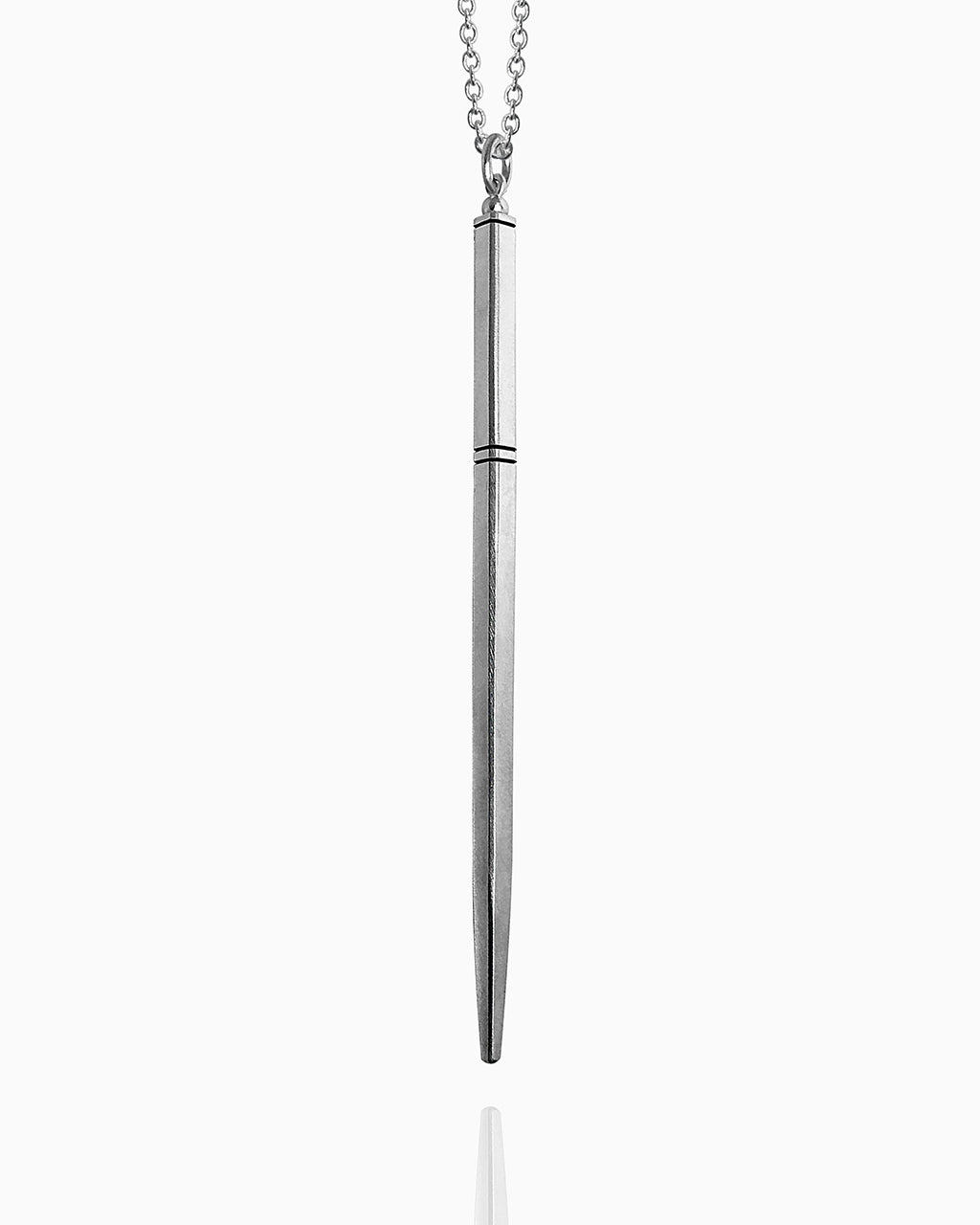 A sterling silver wand necklace hanging against a white background. This wand has a tapered square shape and is completely smooth except for three carved horizontal lines to delineate the wand handle.