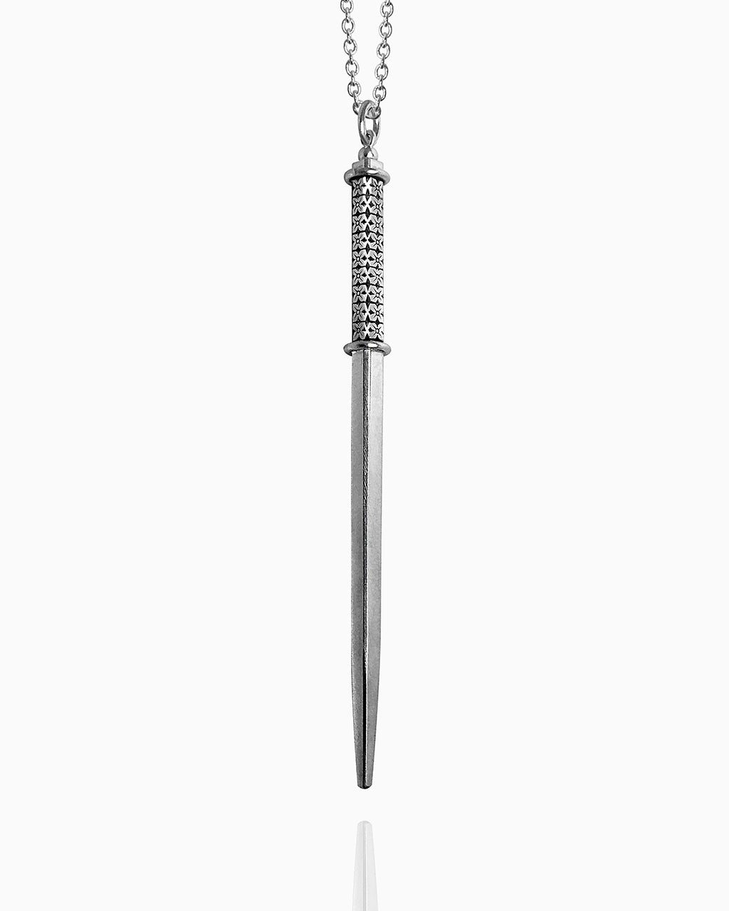 A polished sterling silver wand pendant hangs from a chain against a white background. The square shape has two silver rings around it—one at the top and another one-third of the way down the wand to define the handle. Between those rings, the handle of the wand is hand-engraved with a floral pattern on all four sides.
